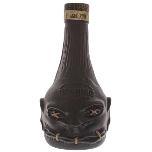 Unique dark bottle of Deadhead aged rum shaped like a shrunken head, premium spirits product.