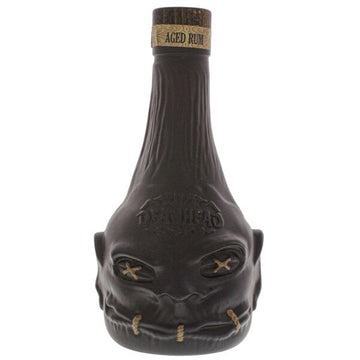 Unique dark bottle of Deadhead aged rum shaped like a shrunken head, premium spirits product.