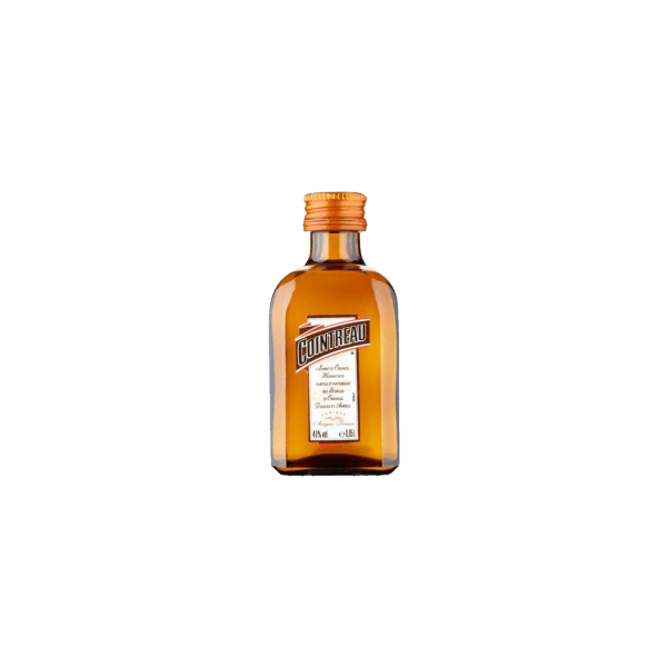 Miniature amber bottle of Cointreau liqueur with label and orange cap on white background