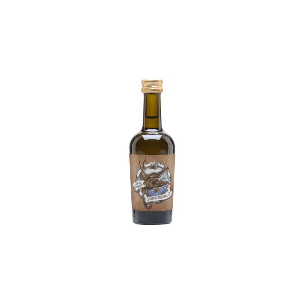 Small green glass bottle with gold cap and vintage-style label featuring a crocodile and the text Authentic Crocodile Oil