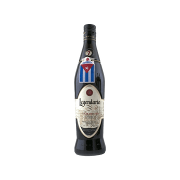 Legendario Cuban rum bottle with label and Cuban flag on green background