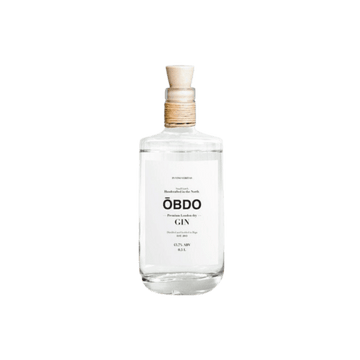 Clear bottle of OBODO premium London dry gin with natural cork stopper and minimal white label
