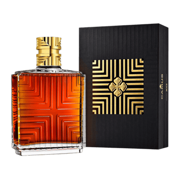 Square bottle of amber liquor with gold geometric pattern and black box with matching gold design