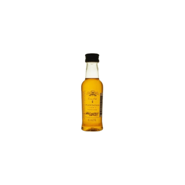 Mini bottle of premium golden rum with black cap on plain background